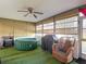 A patio featuring a hot tub, grill, and rattan chair at 9425 Sterling Ln, Port Richey, FL 34668