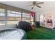 Enclosed sunroom with green carpet and a ceiling fan with glass sliding doors at 9425 Sterling Ln, Port Richey, FL 34668