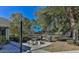 Outdoor barbecue area with charcoal grills, picnic table and mature trees at 9474 Nakoma Way # E, Weeki Wachee, FL 34613