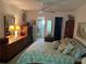 Bedroom featuring dressers, bed, mirrors, and shelving at 9474 Nakoma Way # E, Weeki Wachee, FL 34613