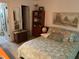 Bedroom featuring a bed, nightstand, and wall decor at 9474 Nakoma Way # E, Weeki Wachee, FL 34613