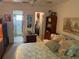 Bedroom featuring a bed, dressers, mirrors and ensuite bath at 9474 Nakoma Way # E, Weeki Wachee, FL 34613