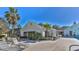 Community clubhouse with lounge chairs, a pool and tropical landscaping at 9474 Nakoma Way # E, Weeki Wachee, FL 34613