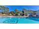 Community pool with pool-side furniture and seating at 9474 Nakoma Way # E, Weeki Wachee, FL 34613