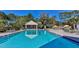 Community pool surrounded by seating at 9474 Nakoma Way # E, Weeki Wachee, FL 34613