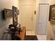 Inviting entryway featuring tiled floors, a front door, closet, and charming decor on a wooden console table at 9474 Nakoma Way # E, Weeki Wachee, FL 34613