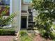 Inviting front entrance with well-maintained landscaping and charming curb appeal at 9474 Nakoma Way # E, Weeki Wachee, FL 34613