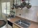 Galley kitchen featuring a stainless steel sink and wood cabinets at 9474 Nakoma Way # E, Weeki Wachee, FL 34613