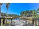 Stunning view of community lake with deck seating and a lush green landscape at 9474 Nakoma Way # E, Weeki Wachee, FL 34613