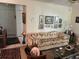 Comfortable living room features a patterned sofa, decorative artwork, and a glass coffee table with decor at 9474 Nakoma Way # E, Weeki Wachee, FL 34613