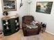 Comfortable living room with a recliner, lamp, and stylish decor at 9474 Nakoma Way # E, Weeki Wachee, FL 34613