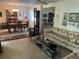 Spacious living room connected to the dining area, featuring a patterned sofa, glass table, and cozy furnishings at 9474 Nakoma Way # E, Weeki Wachee, FL 34613