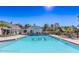 Sparkling community pool with ample seating and clubhouse access on a sunny day at 9474 Nakoma Way # E, Weeki Wachee, FL 34613