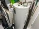 A hot water heater is surrounded by cleaning supplies and storage items at 9474 Nakoma Way # E, Weeki Wachee, FL 34613