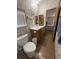 Bathroom has a toilet, a vanity with drawers, a mirror, and a medicine cabinet at 10654 Holgate St, New Port Richey, FL 34654