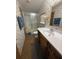 Bathroom featuring a shower, a toilet, a vanity with cabinet space, and wallpaper at 10654 Holgate St, New Port Richey, FL 34654