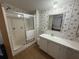 Bathroom features a shower, a vanity with storage, and a floral wallpaper at 10654 Holgate St, New Port Richey, FL 34654