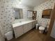 Bright bathroom features a vanity, a toilet, and a small cabinet for storage at 10654 Holgate St, New Port Richey, FL 34654