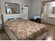 Cozy bedroom features a large bed, a TV, and an en-suite bathroom for added convenience at 10654 Holgate St, New Port Richey, FL 34654