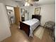 Bedroom boasts a bed, chair, and easy access to the bathroom and closet at 10654 Holgate St, New Port Richey, FL 34654