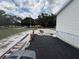View of the driveway that leads to the house and features construction material for improvements at 10654 Holgate St, New Port Richey, FL 34654