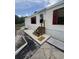 Exterior view of the home's front entrance, featuring new steps, a concrete pad and red shutters at 10654 Holgate St, New Port Richey, FL 34654