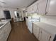 Bright kitchen features white cabinets, modern appliances, wood-look floors and ample counter space for meal preparation at 10654 Holgate St, New Port Richey, FL 34654