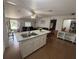 Open-concept kitchen with an island overlooking the cozy living room, creating a seamless flow and inviting atmosphere at 10654 Holgate St, New Port Richey, FL 34654