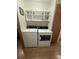 This laundry room features a washer and dryer with overhead shelving for easy organization at 10654 Holgate St, New Port Richey, FL 34654