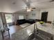 Inviting living room featuring wood-look floors, neutral walls, and a comfortable seating area with an open doorway at 10654 Holgate St, New Port Richey, FL 34654