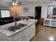 Open-concept kitchen with an island overlooking the cozy living room, creating a seamless flow and inviting atmosphere at 10654 Holgate St, New Port Richey, FL 34654
