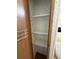 Functional pantry with built-in shelving provides ample storage for groceries and household essentials in an easy to reach place at 10654 Holgate St, New Port Richey, FL 34654