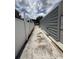 The side yard features a gravel path between the house and a white fence at 10654 Holgate St, New Port Richey, FL 34654