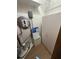 This utility closet has some storage space and the water filtration system for the home at 10654 Holgate St, New Port Richey, FL 34654