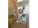 This utility closet has storage shelves, a water heater, and a water filtration system for the home at 10654 Holgate St, New Port Richey, FL 34654