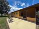 View of backyard with bench and rear of house at 11094 Auburndale St, Spring Hill, FL 34609