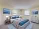 Staged bedroom features neutral tones, plush carpet, and a comfortable bed with blue accents at 11094 Auburndale St, Spring Hill, FL 34609