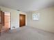 Bedroom features plush carpet, a window, closet and a doorway leading to the kitchen at 11094 Auburndale St, Spring Hill, FL 34609