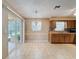 Charming dining area adjacent to the kitchen, featuring a chandelier and tiled flooring at 11094 Auburndale St, Spring Hill, FL 34609
