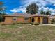 Charming single-story home featuring a well-kept lawn, manicured shrubs, and an attached garage at 11094 Auburndale St, Spring Hill, FL 34609