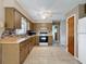 Efficient kitchen with tiled flooring, wood cabinetry, and modern appliances; ready for cooking and dining at 11094 Auburndale St, Spring Hill, FL 34609
