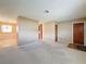 Spacious open-concept living area with neutral carpeting and walls, ready for customization and decor at 11094 Auburndale St, Spring Hill, FL 34609