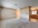Comfortable living area with plush carpeting, neutral walls, and ample seating around a central ottoman at 11094 Auburndale St, Spring Hill, FL 34609