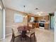 Open-concept living space transitioning to a kitchen, perfect for modern living and entertaining at 11094 Auburndale St, Spring Hill, FL 34609
