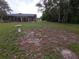 Spacious backyard featuring a screened lanai, mature trees, and outdoor entertaining area at 11263 Murraysville Dr, Spring Hill, FL 34609