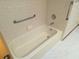 Standard bathtub with shower and grab bar in the bathroom at 11263 Murraysville Dr, Spring Hill, FL 34609