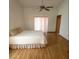 Bright bedroom featuring a ceiling fan, light walls, and wood-look flooring at 11263 Murraysville Dr, Spring Hill, FL 34609