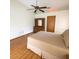 Bedroom with wood flooring, a ceiling fan, and a wooden dresser with mirror at 11263 Murraysville Dr, Spring Hill, FL 34609