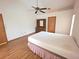 A bedroom featuring a ceiling fan, wood floors, and a dresser at 11263 Murraysville Dr, Spring Hill, FL 34609