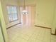 Bright dining space with white tile flooring, a pendant light fixture, and soft window coverings at 11263 Murraysville Dr, Spring Hill, FL 34609
